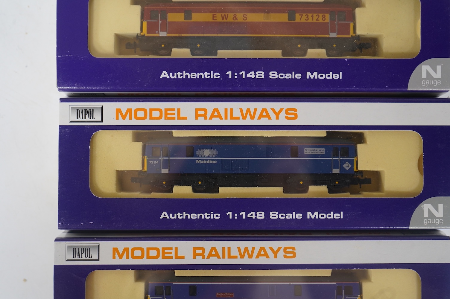 Three boxed Dapol N gauge railway Class 73 electro-diesel locomotives; 73109 Battle of Britain (ND006), 73114 Stewarts Lane (ND-021a) and 73128 (ND005). Condition - good.